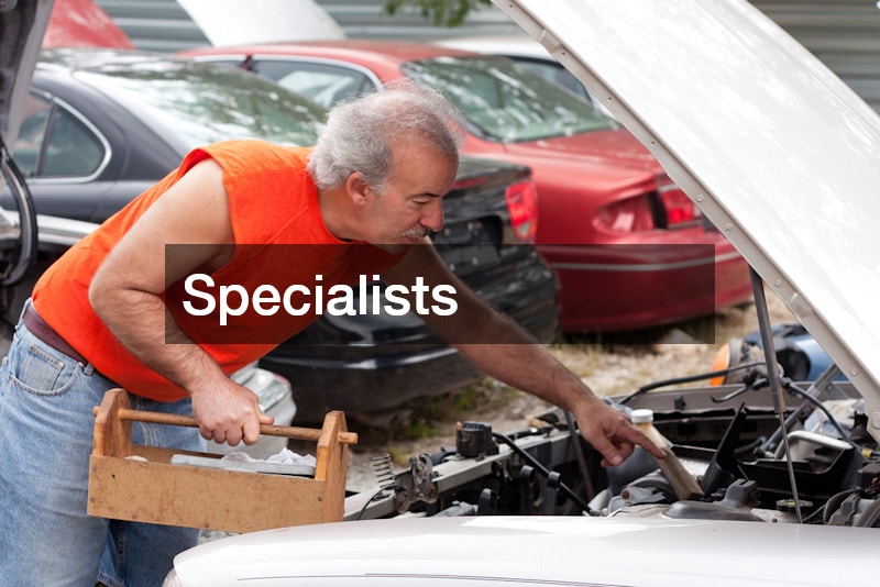 mechanic looking at car parts