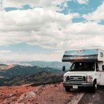 RV parked by the roadside, with mountain views