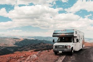 RV parked by the roadside, with mountain views